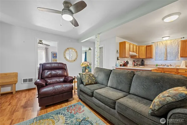 a living room with furniture a window and a chandelier
