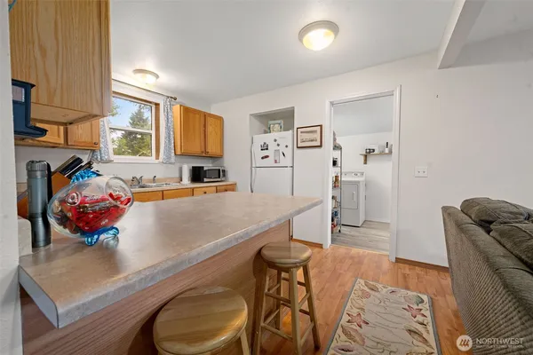 a kitchen with a sink cabinets stainless steel appliances and a window