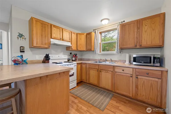 a kitchen with stainless steel appliances a refrigerator sink and cabinets