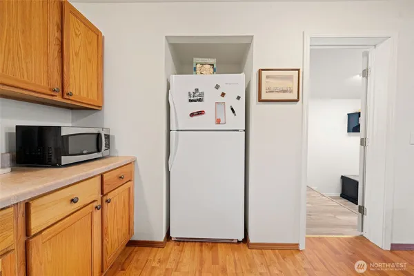 a kitchen with stainless steel appliances granite countertop white cabinets sink and a granite counter top