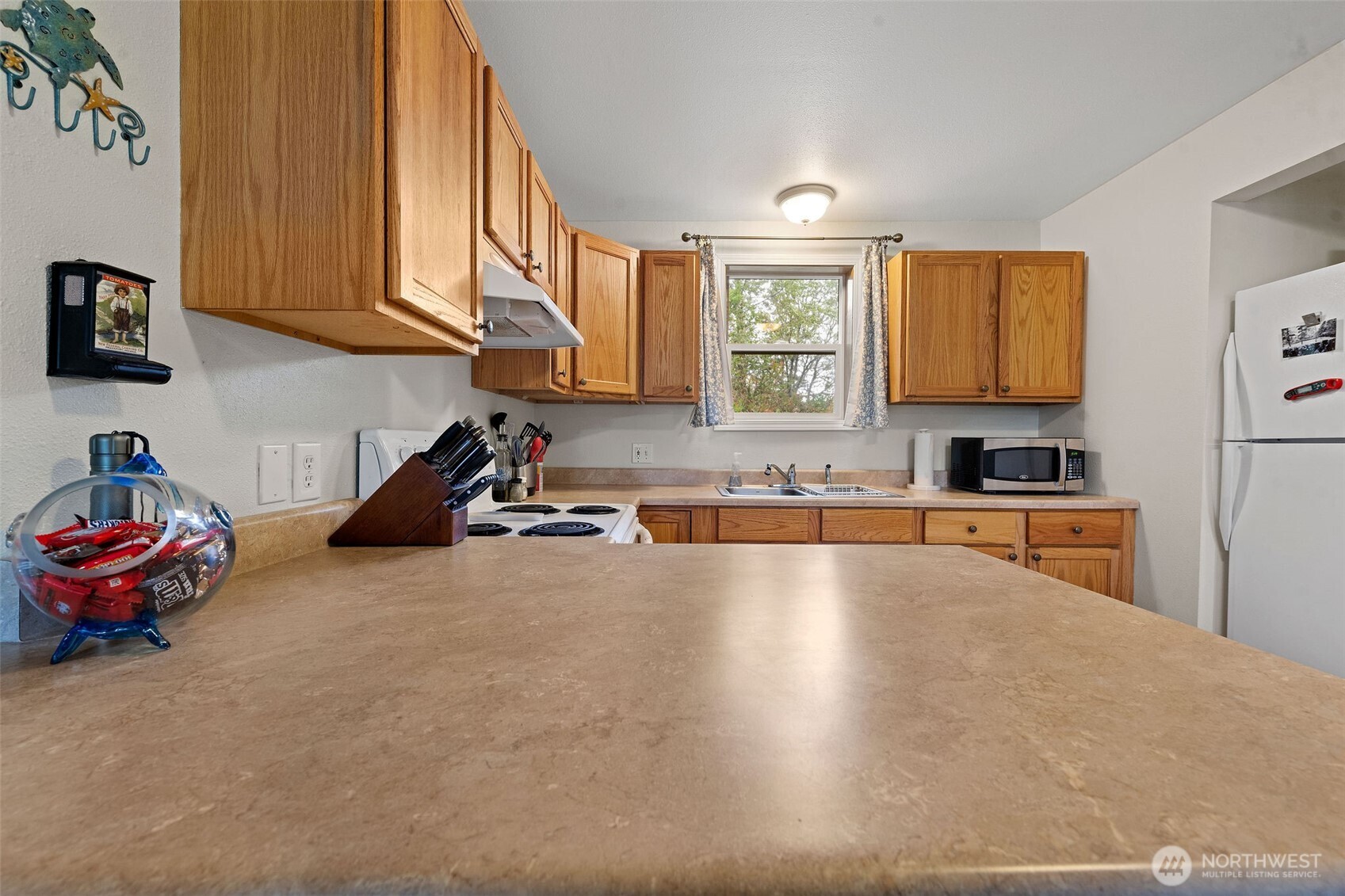 2019 Joe Johns Road Ocean Park, WA 98640 - Photo 17 of 28 a kitchen with granite countertop a stove a sink and a microwave