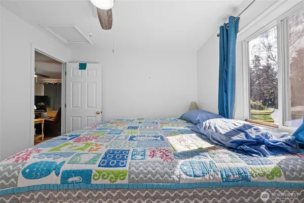 a bedroom with a bed and window