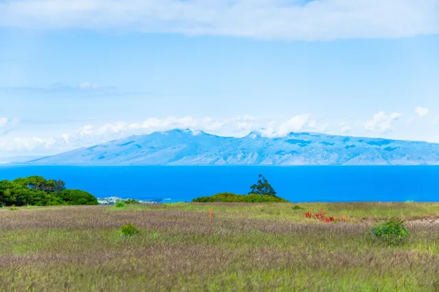 a view of an ocean and a mountain