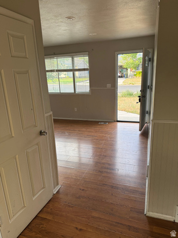 874 770 South Tooele, UT 84074 - Photo 7 of 19 Entry area featuring wood-finish flooring, white paneled wainscoting, and recessed lighting