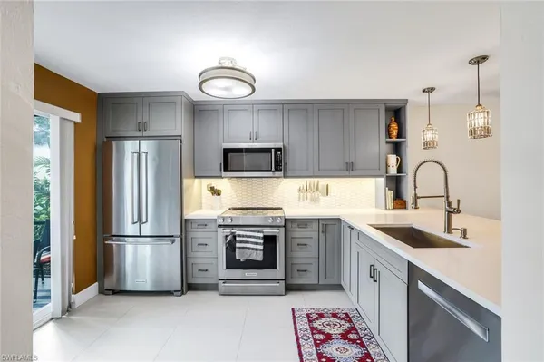 a kitchen with a sink stainless steel appliances and cabinets