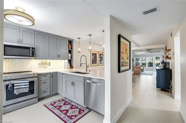 a kitchen with stainless steel appliances granite countertop a refrigerator and stove