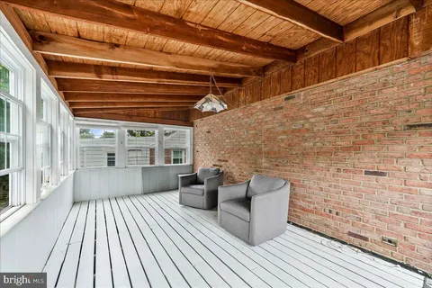 a view of a balcony with wooden floor