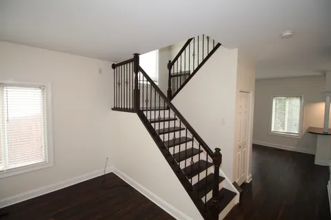a view of entryway with wooden floor and stairs