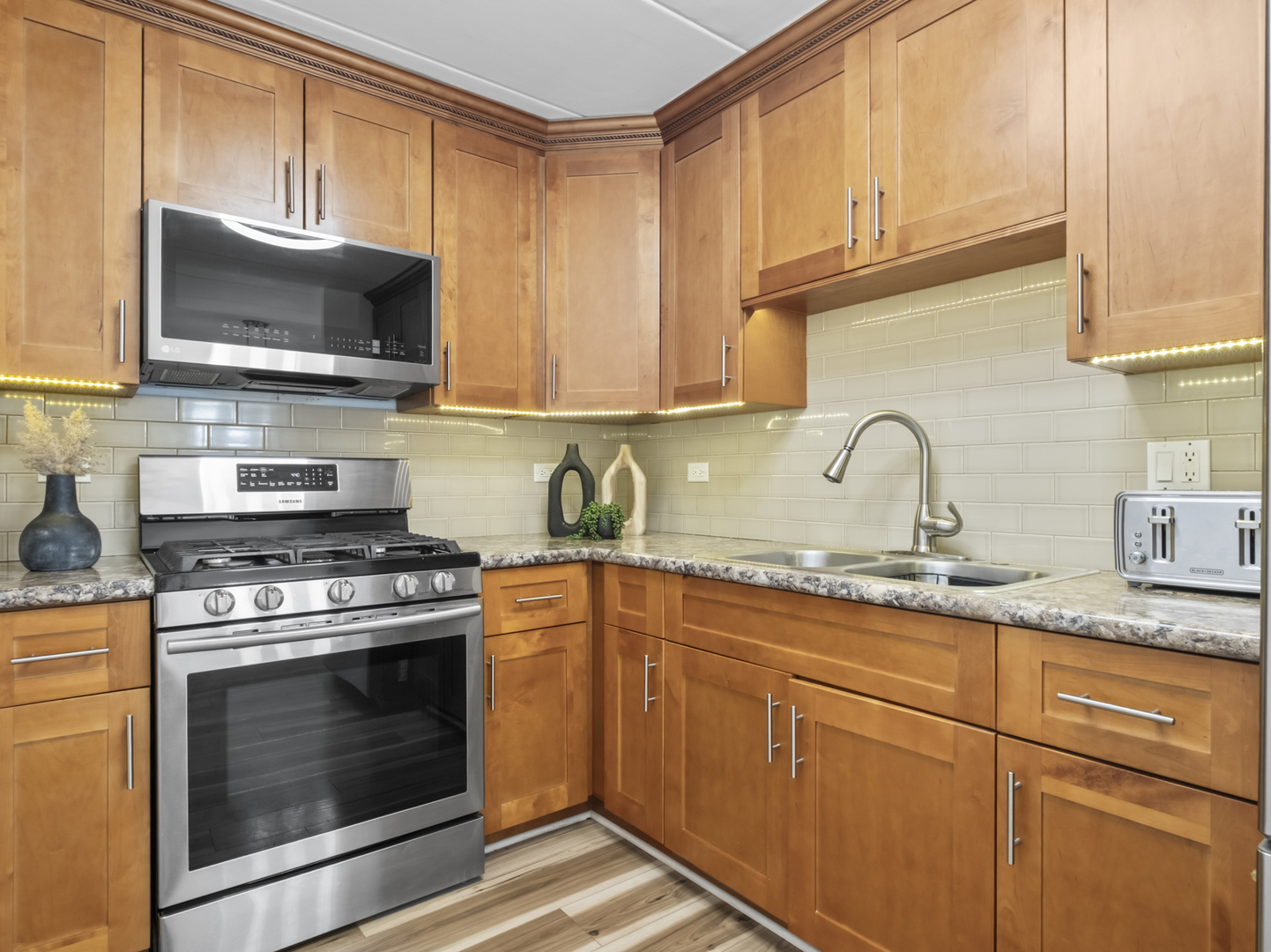 2521 Thatcher Avenue, Unit 2I River Grove, IL 60171 - Photo 7 of 18 a kitchen with granite countertop a stove top oven microwave and cabinets