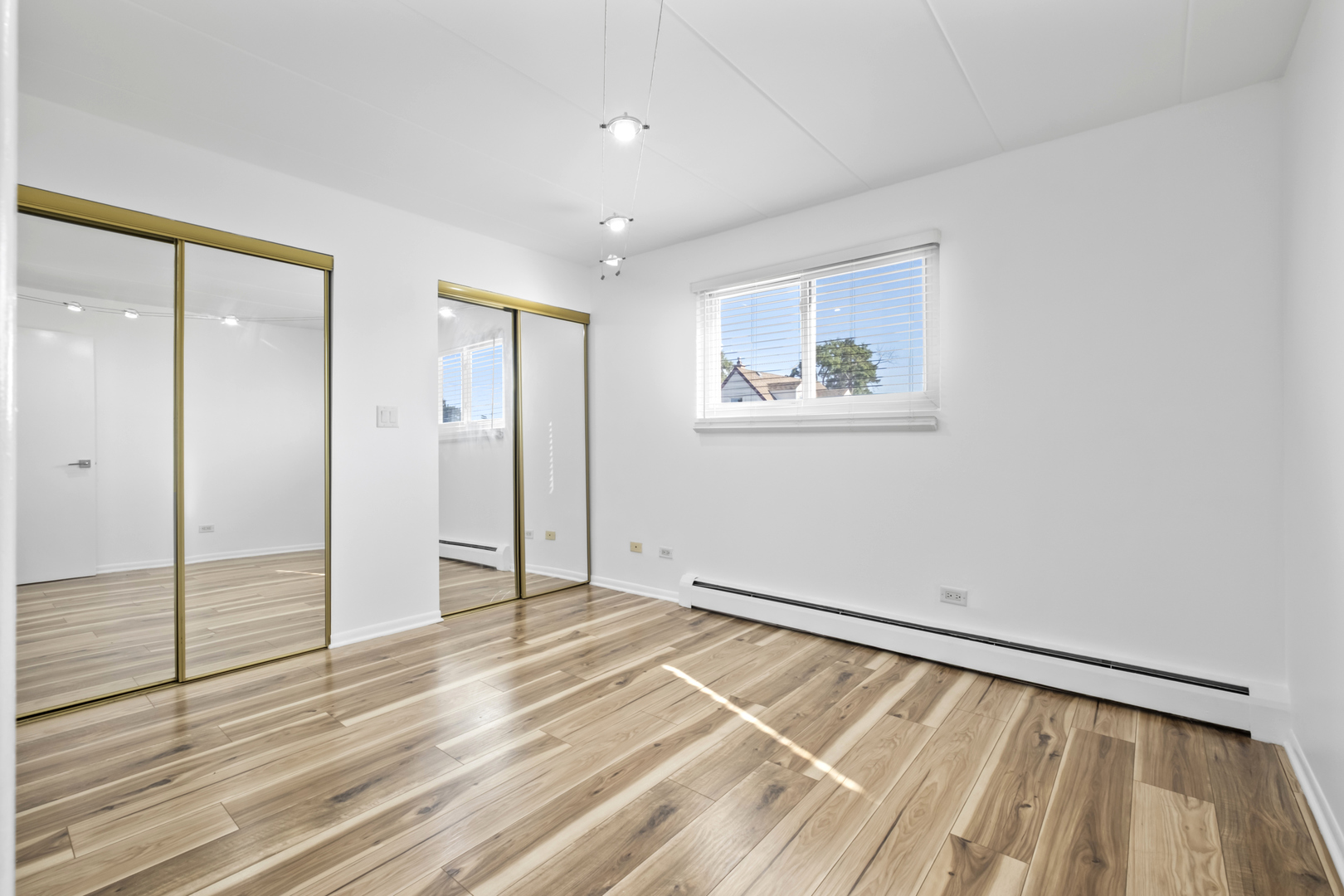 2521 Thatcher Avenue, Unit 2I River Grove, IL 60171 - Photo 9 of 18 a view of an empty room with wooden floor and a window