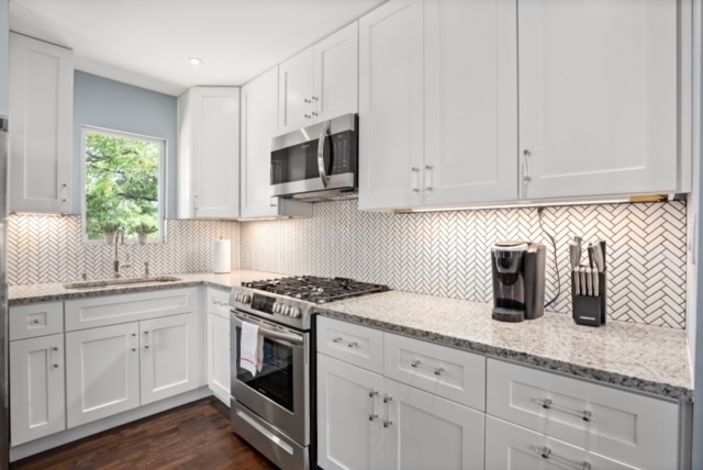 1183 Coleto Street Austin, TX 78702 - Photo 9 of 17 a kitchen with white cabinets and white appliances