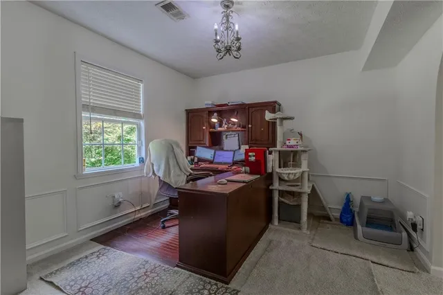 a room with table chairs and entryway