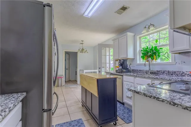 a kitchen with stainless steel appliances granite countertop a sink stove and cabinets