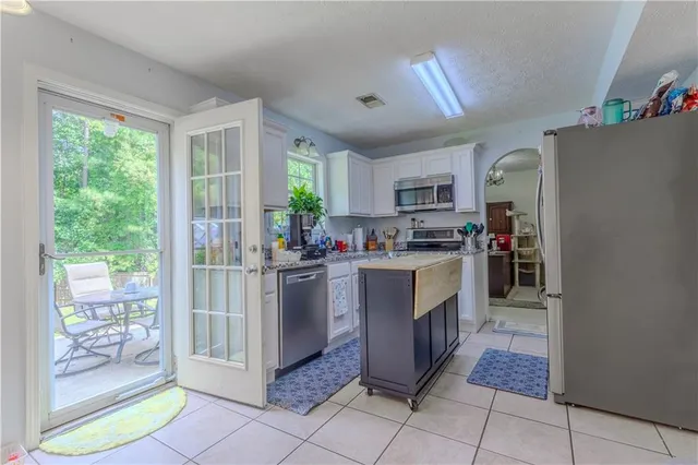 a kitchen with a refrigerator and a stove top oven