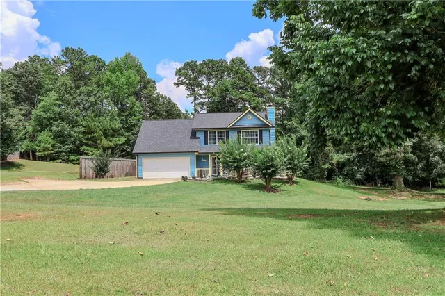 a front view of a house with a yard