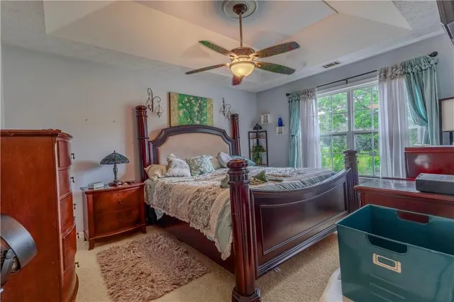 a bed sitting in a bedroom next to a window