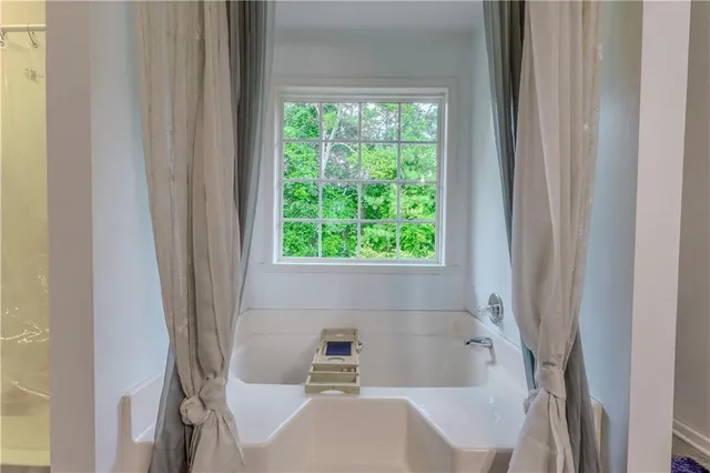 a bathroom with a tub and shower