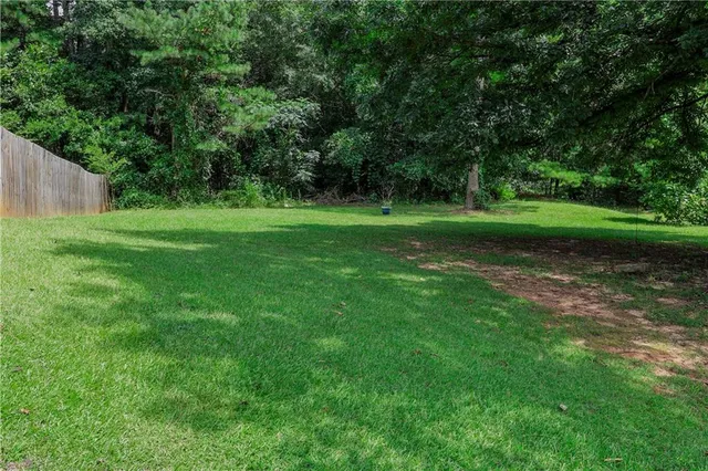 a view of a park with trees in the background