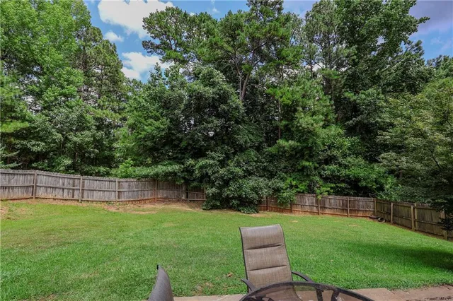 a view of a backyard with a garden and entertaining space