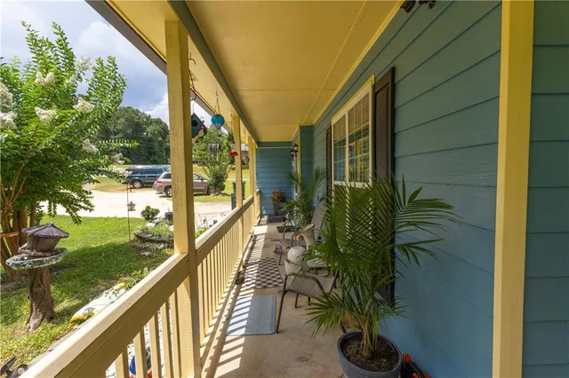 a backyard of a house with garden and outdoor seating