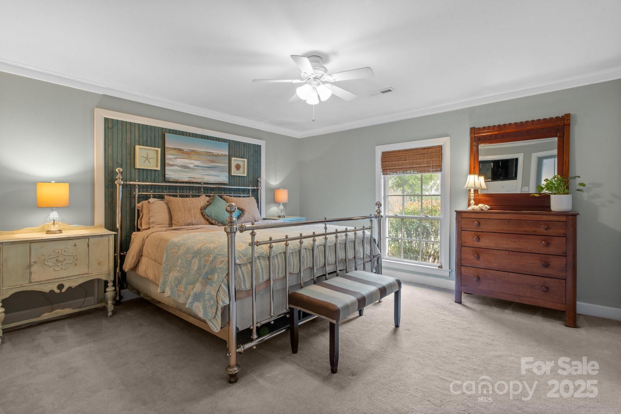 13031 Westmoreland Farm Road Davidson, NC 28036 - Photo 24 of 45 a bedroom with a bed and a chandelier