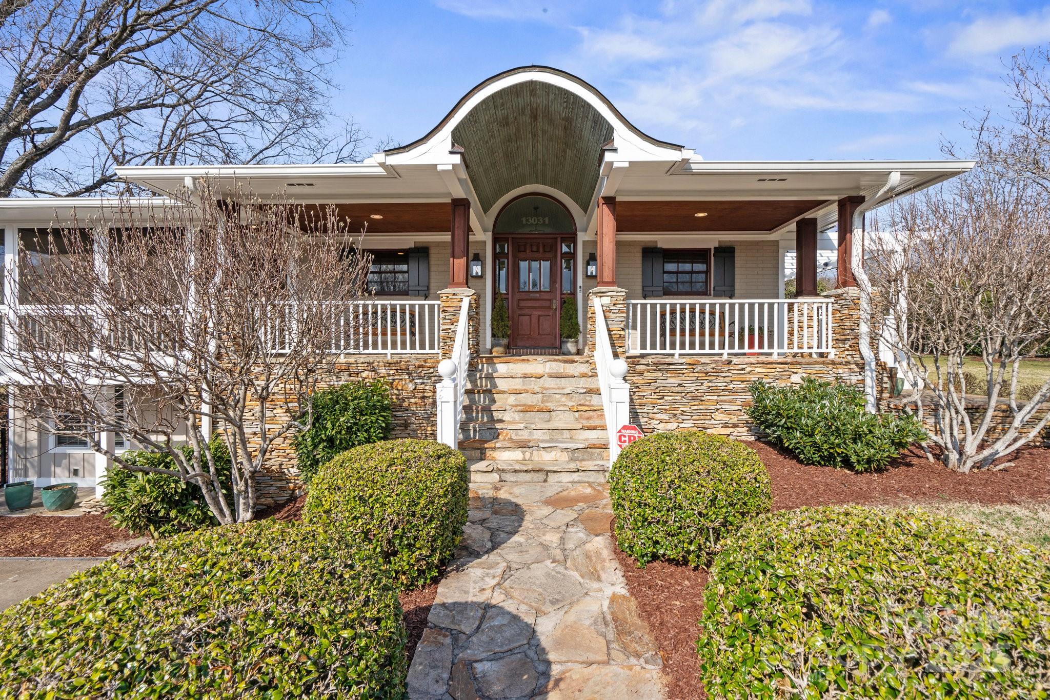 13031 Westmoreland Farm Road Davidson, NC 28036 - Photo 3 of 45 a view of a brick house with potted plants