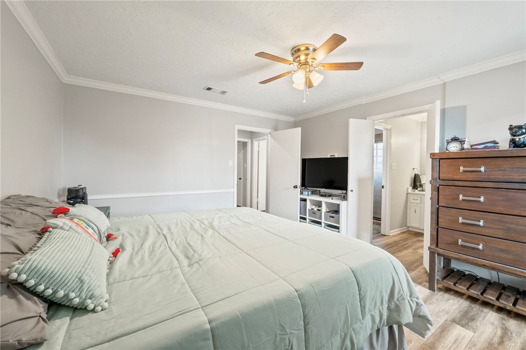 2911 Oakside Drive Bryan, TX 77802 - Photo 11 of 23 a bedroom with a bed and a flat screen tv