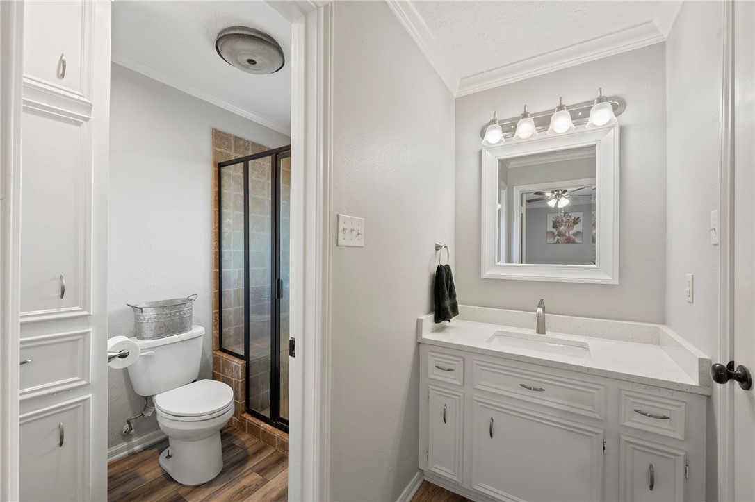 2911 Oakside Drive Bryan, TX 77802 - Photo 12 of 23 a bathroom with a toilet sink and mirror