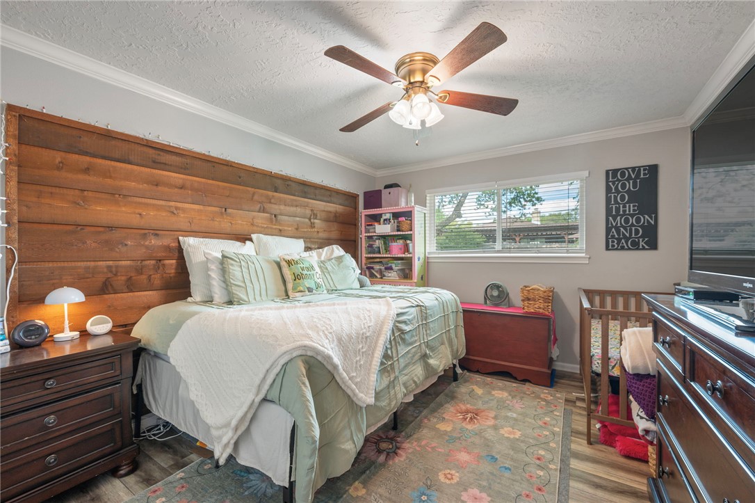 2911 Oakside Drive Bryan, TX 77802 - Photo 13 of 23 a bed room with a bed and a chandelier