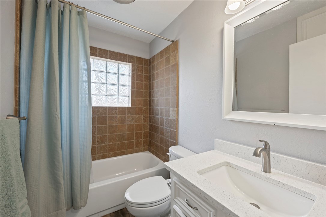 2911 Oakside Drive Bryan, TX 77802 - Photo 14 of 23 a bathroom with a sink a toilet and shower
