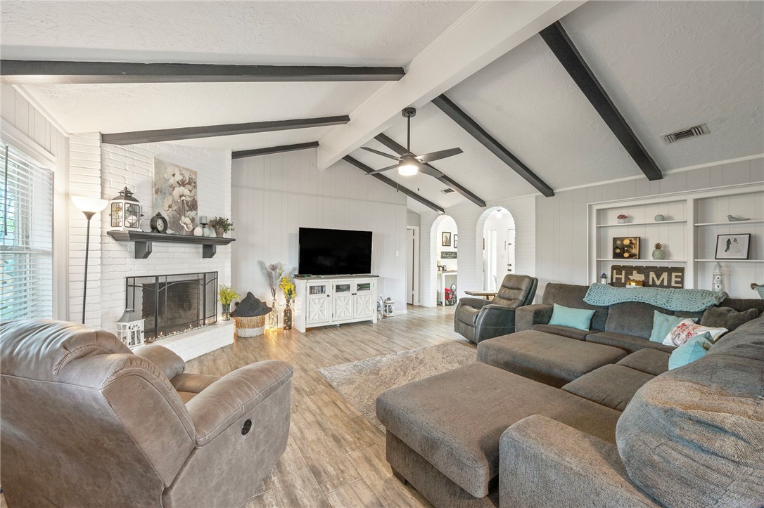 2911 Oakside Drive Bryan, TX 77802 - Photo 3 of 23 a living room with furniture a flat screen tv and a fireplace