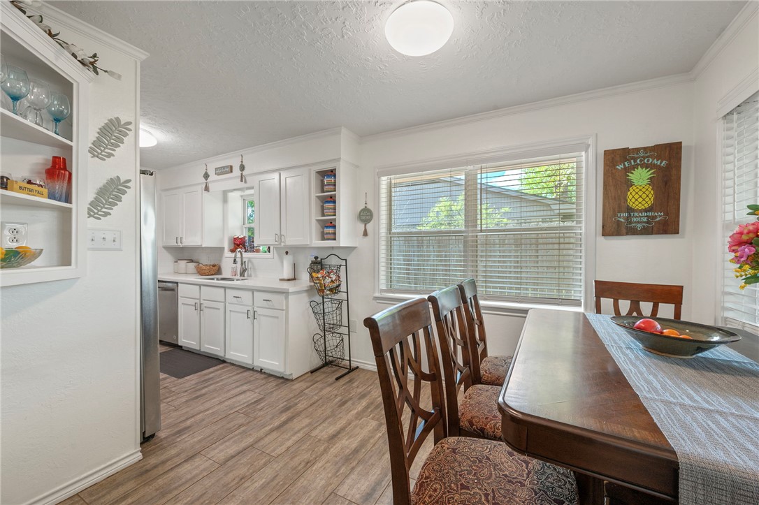 2911 Oakside Drive Bryan, TX 77802 - Photo 5 of 23 a kitchen with a table chairs refrigerator and cabinets