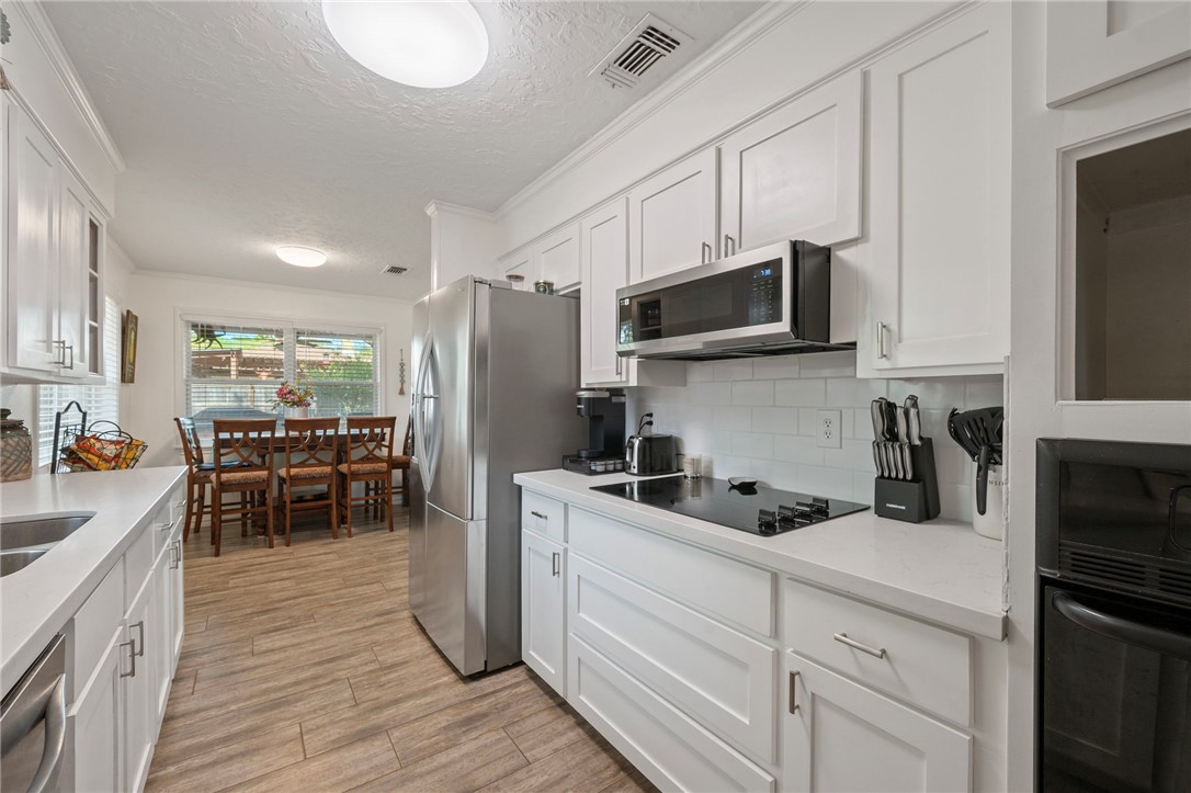 2911 Oakside Drive Bryan, TX 77802 - Photo 7 of 23 a kitchen with a sink microwave and refrigerator