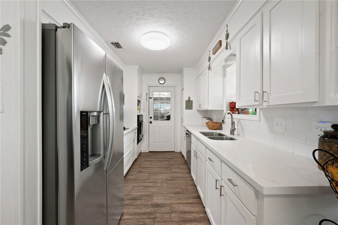 2911 Oakside Drive Bryan, TX 77802 - Photo 8 of 23 a kitchen with white cabinets and refrigerator