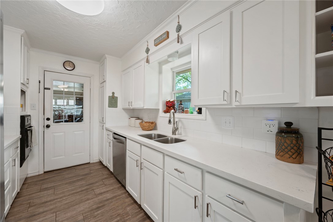 2911 Oakside Drive Bryan, TX 77802 - Photo 9 of 23 a kitchen with stainless steel appliances granite countertop a sink and a white cabinets