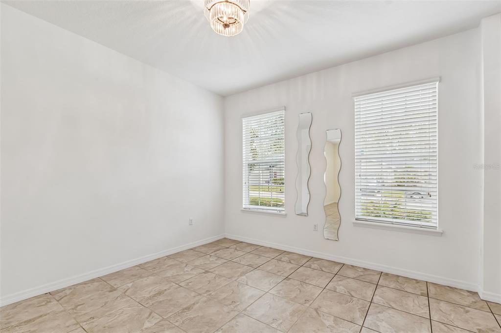6105 Merrifield Drive Zephyrhills, FL 33541 - Photo 14 of 85 an empty room with windows