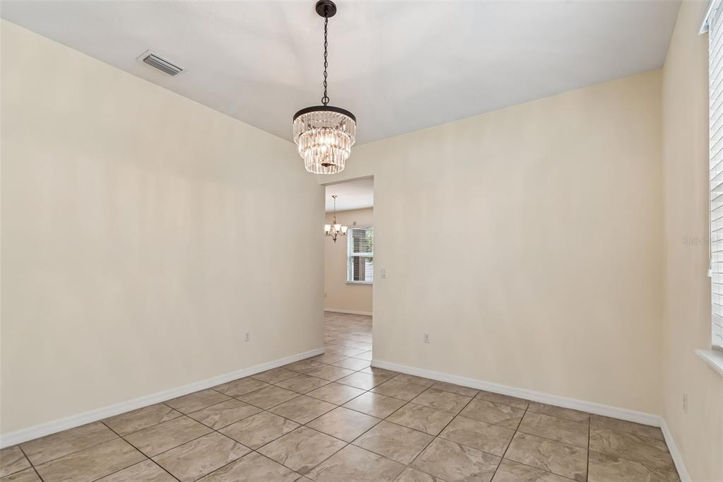 6105 Merrifield Drive Zephyrhills, FL 33541 - Photo 16 of 85 a view of a hallway with wooden floor and a window