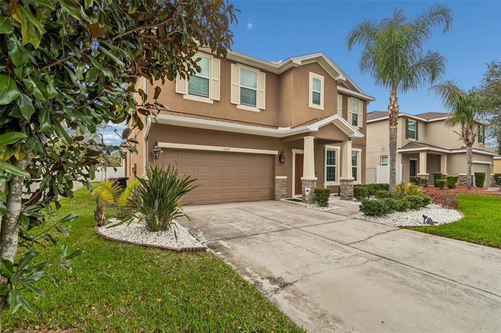 6105 Merrifield Drive Zephyrhills, FL 33541 - Photo 2 of 85 a front view of a house with a yard and garage