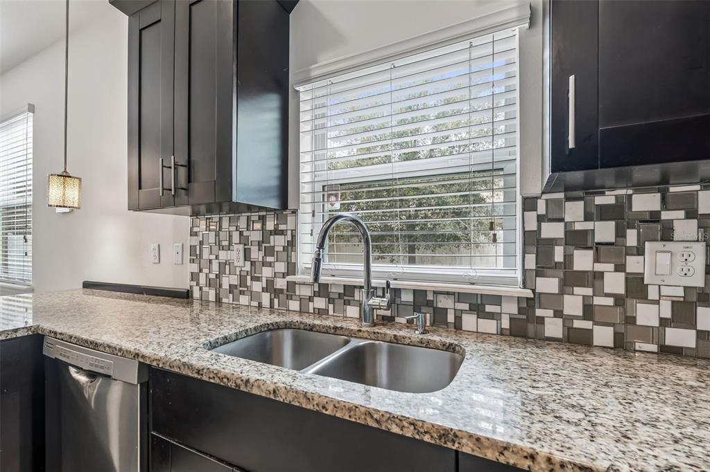 6105 Merrifield Drive Zephyrhills, FL 33541 - Photo 25 of 85 a kitchen with a sink and a wooden cabinets