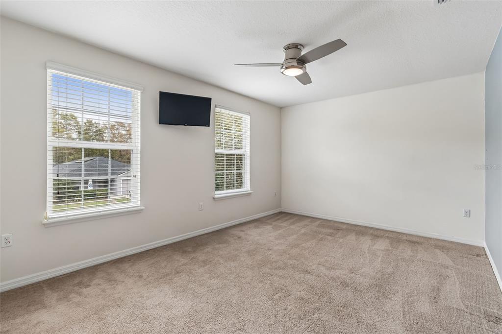 6105 Merrifield Drive Zephyrhills, FL 33541 - Photo 34 of 85 an empty room with windows and ceiling fan