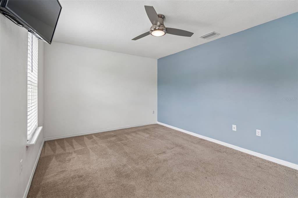 6105 Merrifield Drive Zephyrhills, FL 33541 - Photo 35 of 85 an empty room with a ceiling fan and window