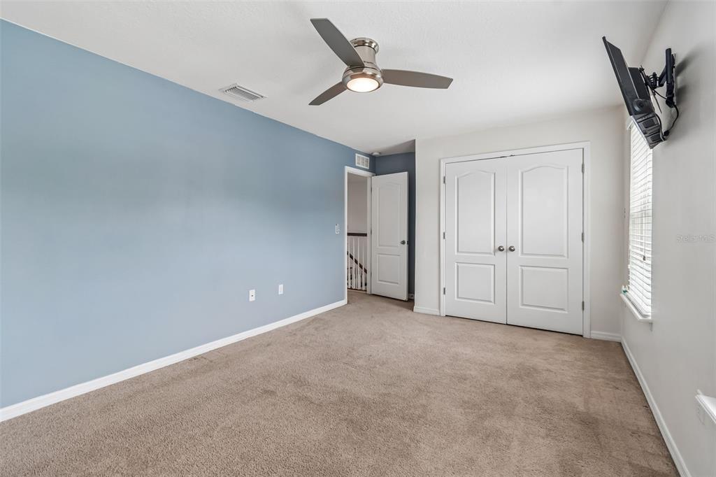6105 Merrifield Drive Zephyrhills, FL 33541 - Photo 36 of 85 an empty room with a ceiling fan and window