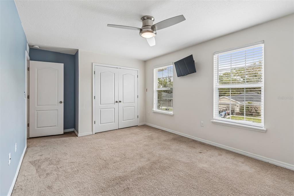 6105 Merrifield Drive Zephyrhills, FL 33541 - Photo 37 of 85 an empty room with windows and ceiling fan