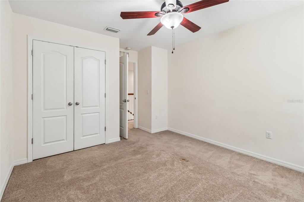 6105 Merrifield Drive Zephyrhills, FL 33541 - Photo 43 of 85 an empty room with closet and a chandelier fan