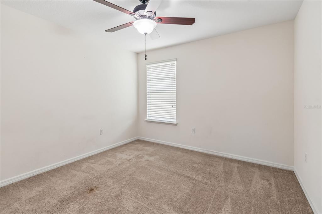 6105 Merrifield Drive Zephyrhills, FL 33541 - Photo 44 of 85 an empty room with a window and a fan