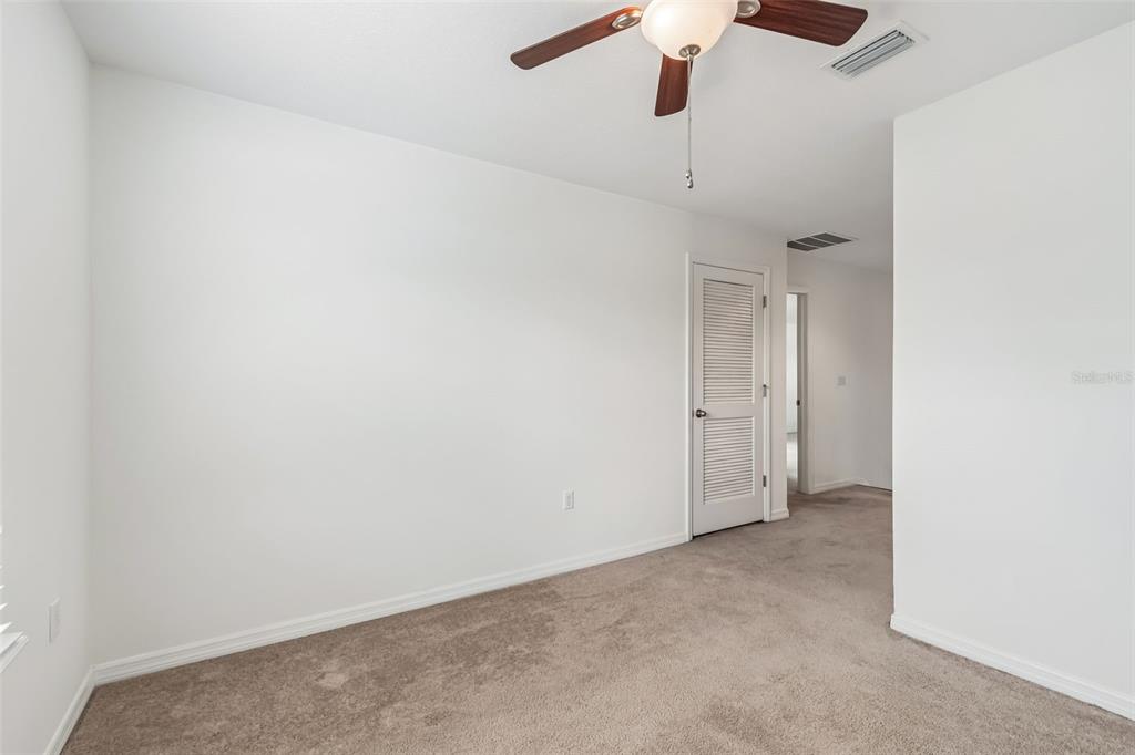 6105 Merrifield Drive Zephyrhills, FL 33541 - Photo 48 of 85 an empty room with a ceiling fan and a window