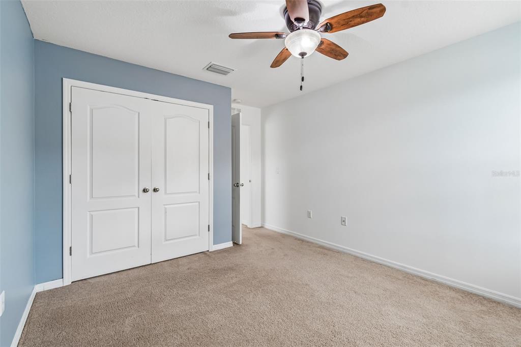6105 Merrifield Drive Zephyrhills, FL 33541 - Photo 52 of 85 an empty room with chandelier fan