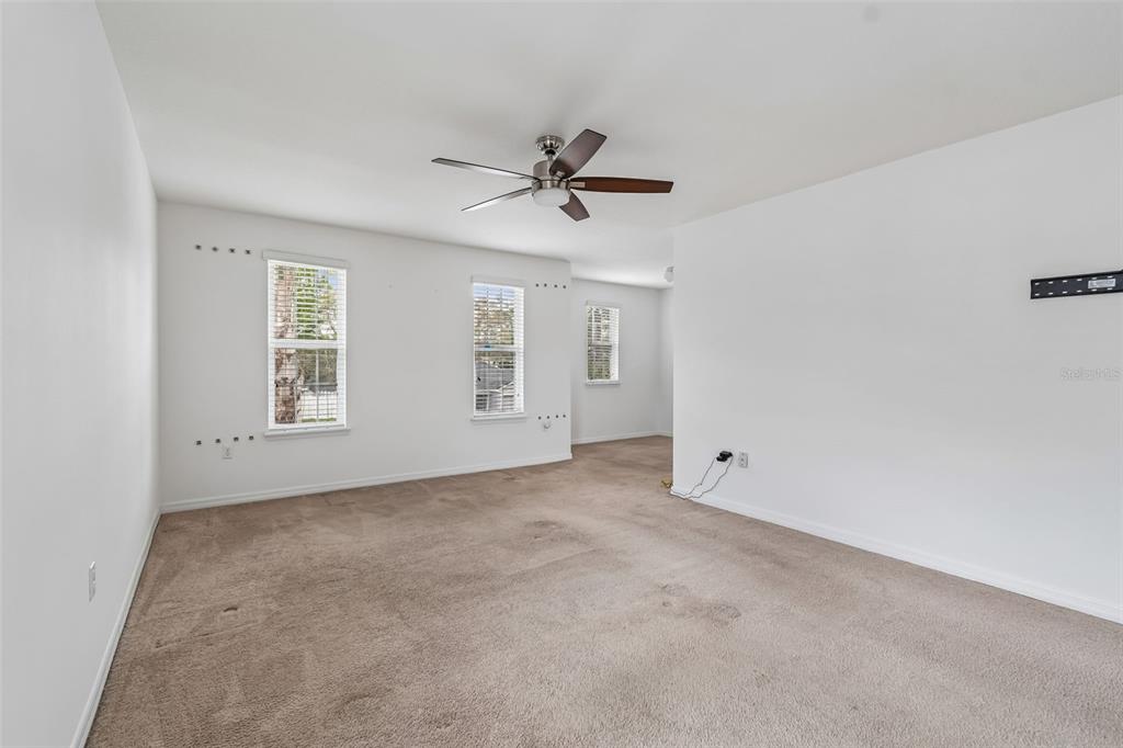 6105 Merrifield Drive Zephyrhills, FL 33541 - Photo 55 of 85 an empty room with windows and fan