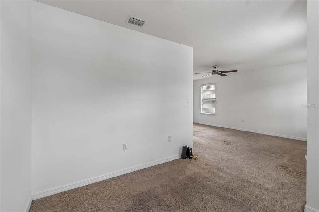 6105 Merrifield Drive Zephyrhills, FL 33541 - Photo 57 of 85 an empty room with windows