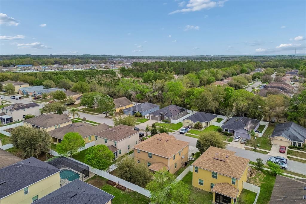 6105 Merrifield Drive Zephyrhills, FL 33541 - Photo 82 of 85 an aerial view of a city with lots of residential buildings and mountain view in back